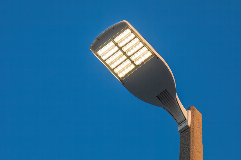 parking lot LED light on a post at sunset