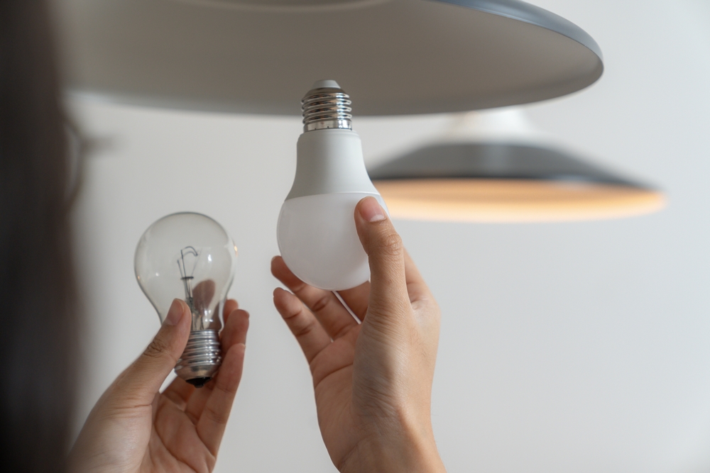 The,Young,Woman,Is,Changing,Light,Bulbs,At,Home